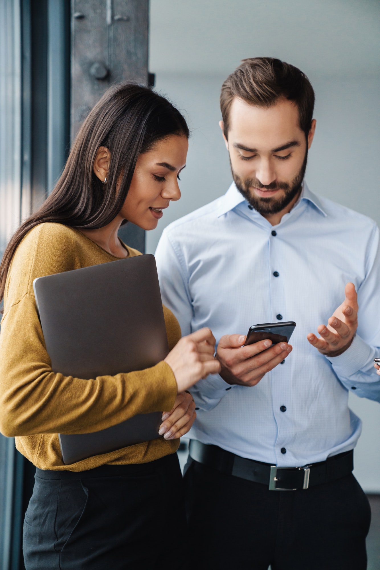 portrait-of-colleagues-talking-and-using-cellphone-while-working-in-office.jpg portrait-of-colleagues-talking-and-using-cellphone-while-working-in-office.jpg